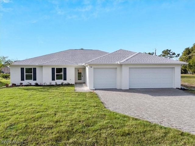 single story home featuring a garage and a front lawn