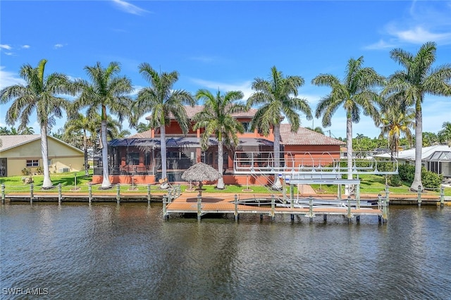 dock area with glass enclosure and a water view