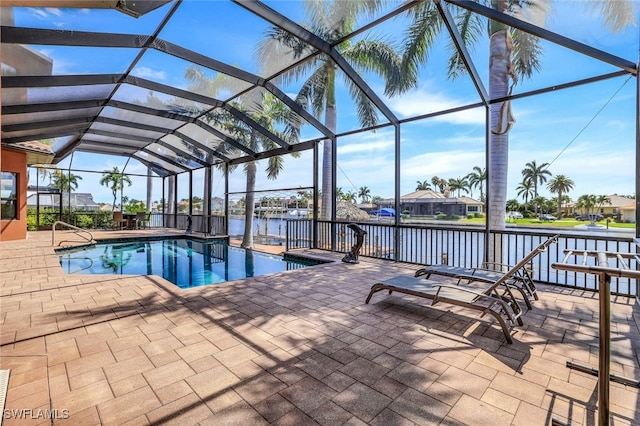 view of swimming pool featuring a water view, glass enclosure, and a patio area