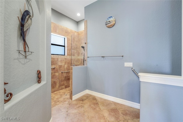 bathroom featuring tiled shower and tile patterned floors