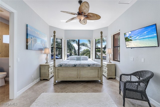 bedroom featuring light tile patterned flooring, ceiling fan, and ensuite bathroom