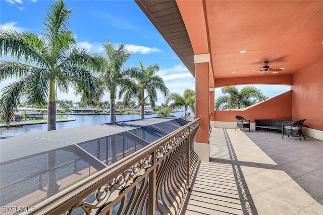 view of patio / terrace featuring a water view and a lanai