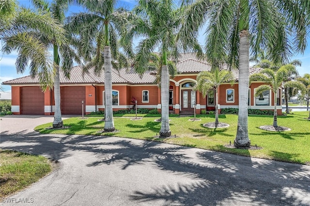 view of front of property featuring a garage and a front lawn