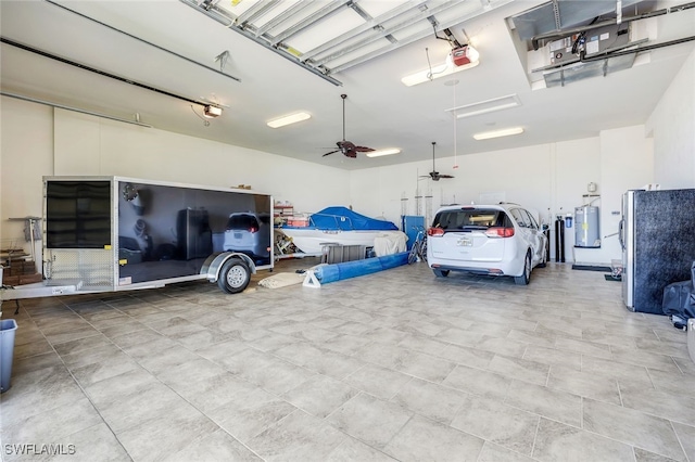 garage with a garage door opener, stainless steel fridge, water heater, and ceiling fan