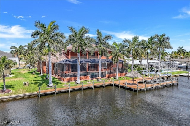 view of dock featuring a water view, a yard, and glass enclosure