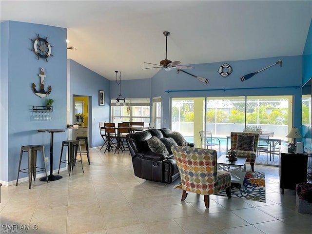 tiled living room with ceiling fan and high vaulted ceiling