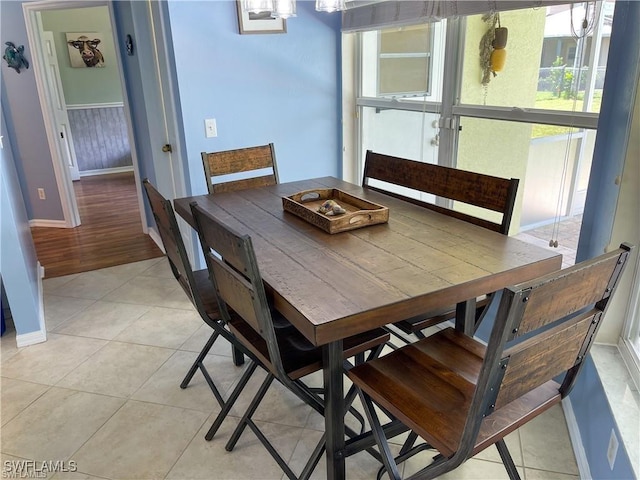 dining area featuring light tile patterned floors