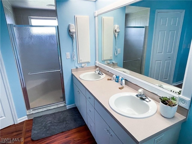 bathroom featuring vanity, an enclosed shower, and hardwood / wood-style floors