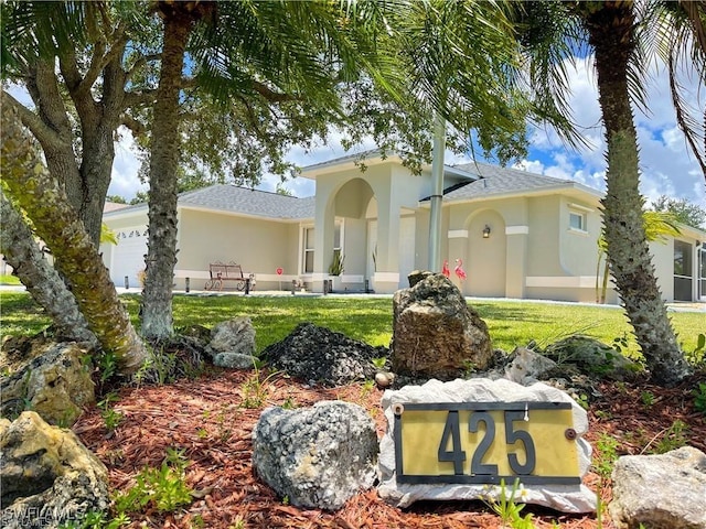 mediterranean / spanish home with a front lawn