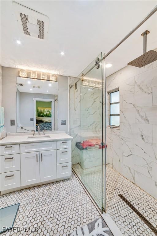 bathroom featuring vanity and an enclosed shower