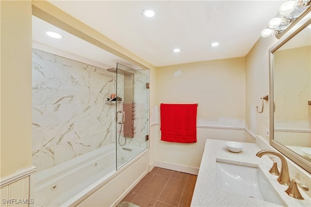 bathroom with enclosed tub / shower combo and vanity