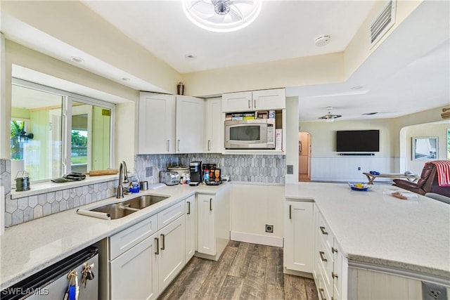 kitchen featuring white cabinetry, sink, a wealth of natural light, and stainless steel appliances