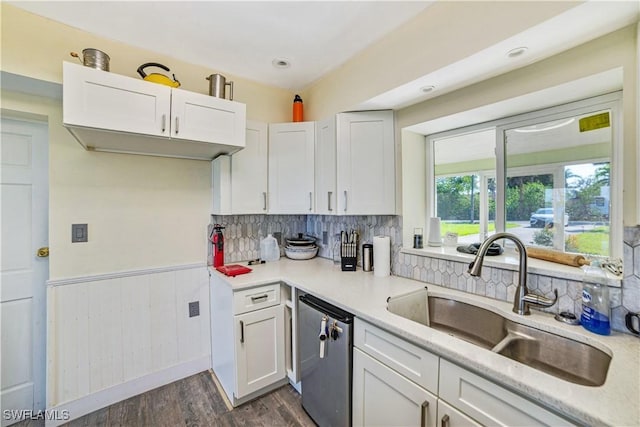 kitchen featuring sink, stainless steel dishwasher, white cabinets, and dark hardwood / wood-style floors