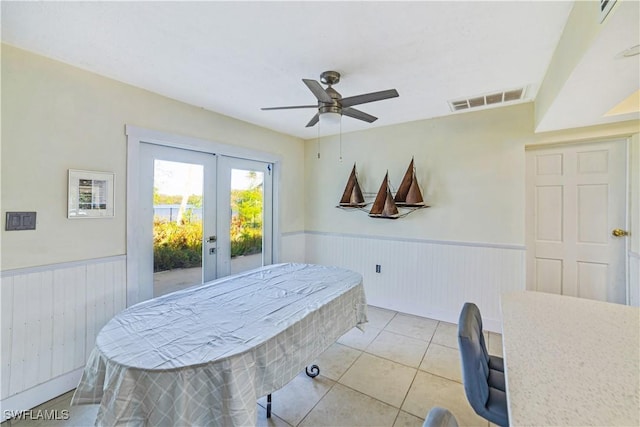 dining space featuring light tile patterned flooring, ceiling fan, and french doors