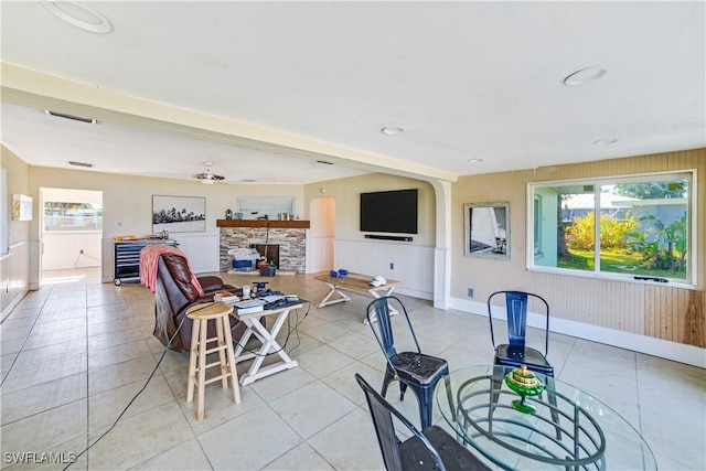 tiled dining room with a fireplace