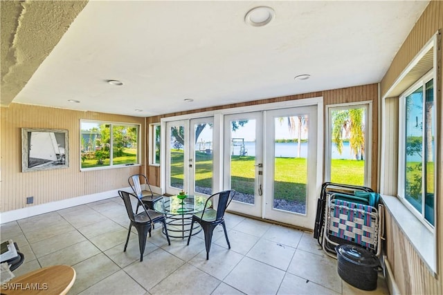 sunroom / solarium featuring a wealth of natural light and french doors