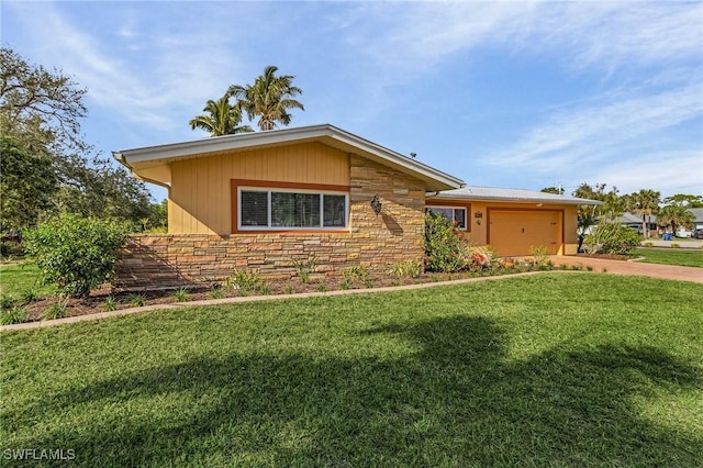 ranch-style house with a garage and a front lawn