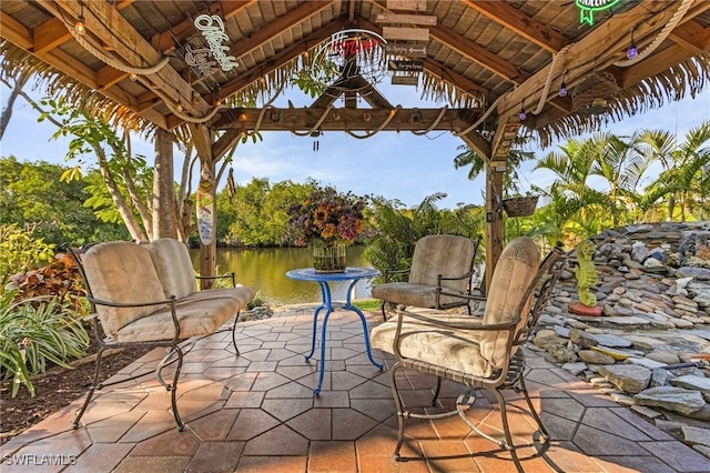 view of patio featuring a gazebo and a water view