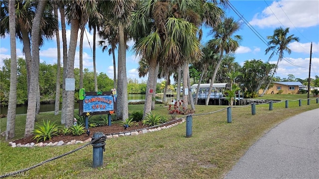 view of community with a water view and a lawn