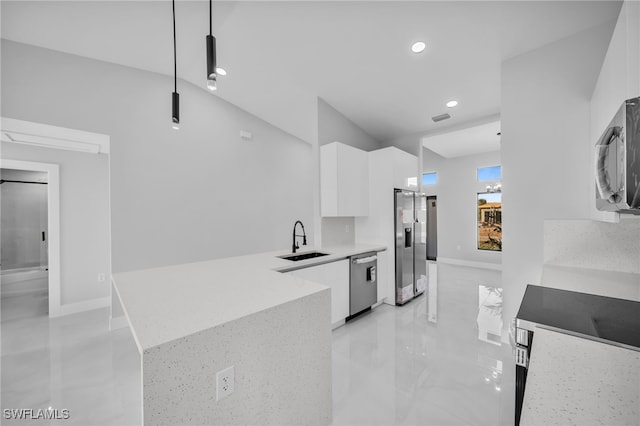 kitchen with decorative light fixtures, white cabinetry, sink, kitchen peninsula, and stainless steel appliances