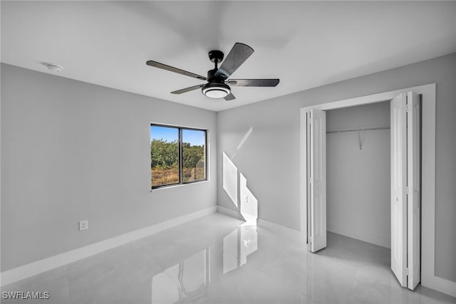 tiled bedroom featuring ceiling fan and a closet