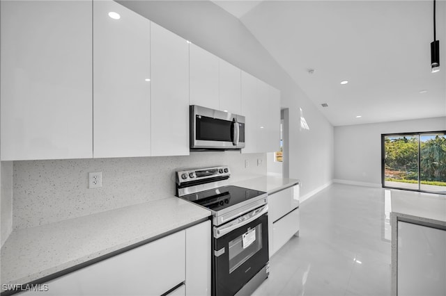 kitchen featuring stainless steel appliances, light stone countertops, decorative backsplash, and white cabinets