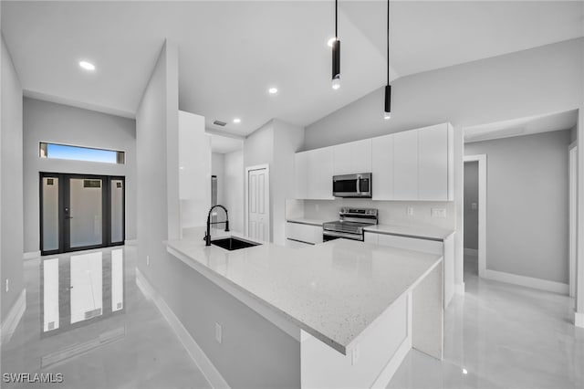 kitchen with sink, hanging light fixtures, appliances with stainless steel finishes, kitchen peninsula, and white cabinets