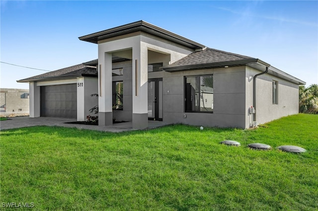 view of front of property with a garage and a front lawn