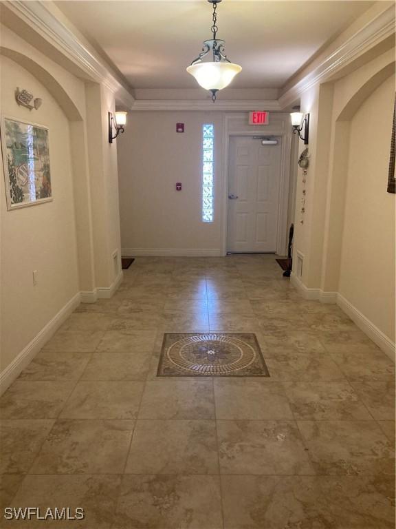 foyer featuring crown molding