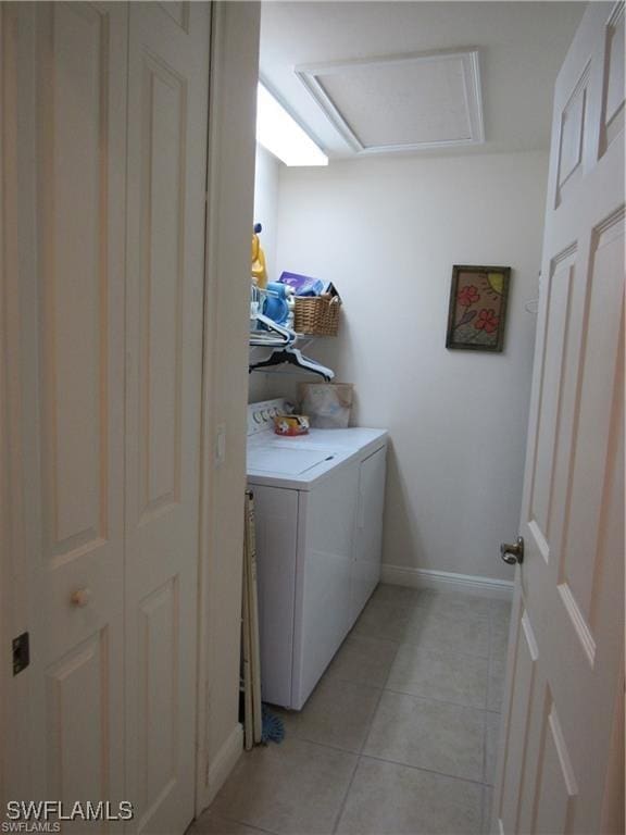 laundry room featuring washer and dryer and light tile patterned floors