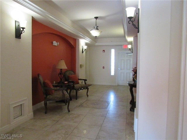 foyer with light tile patterned flooring and a raised ceiling