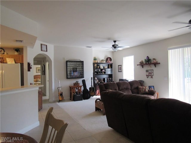 tiled living room featuring ceiling fan