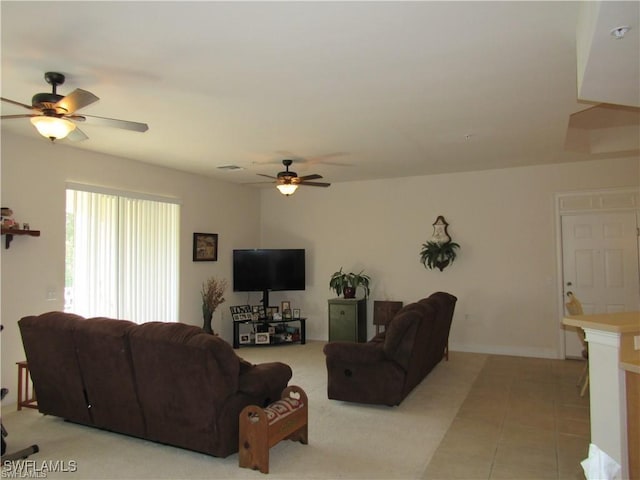 tiled living room featuring ceiling fan