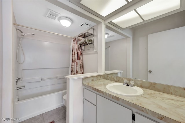 full bathroom featuring vanity, shower / bath combination with curtain, tile patterned floors, and toilet