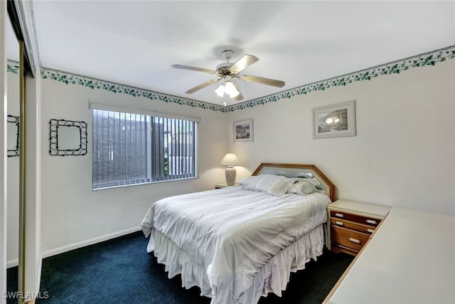 bedroom with ceiling fan and dark carpet