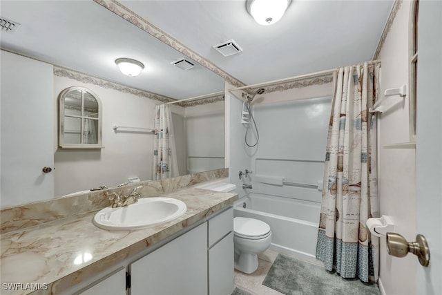 full bathroom with vanity, shower / tub combo with curtain, tile patterned floors, and toilet