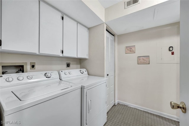 clothes washing area featuring cabinets and washing machine and dryer