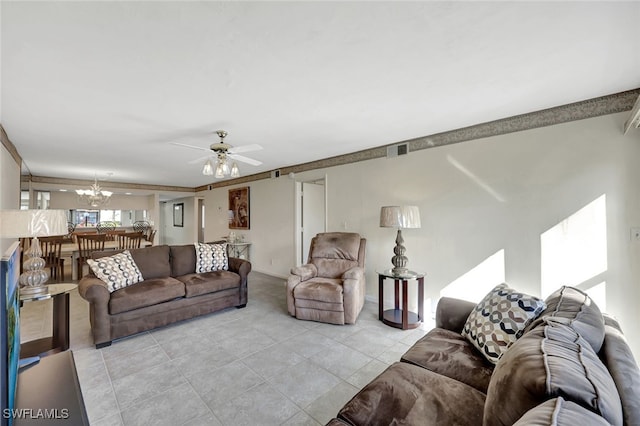 living room featuring light tile patterned floors and ceiling fan with notable chandelier