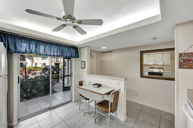 tiled dining room featuring ceiling fan