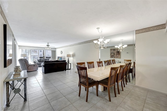 tiled dining area featuring ceiling fan with notable chandelier