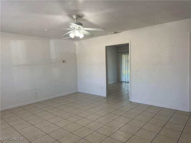 tiled empty room with ceiling fan