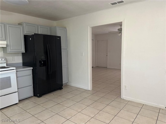 kitchen with black fridge, light tile patterned floors, gray cabinets, ceiling fan, and white range with electric stovetop