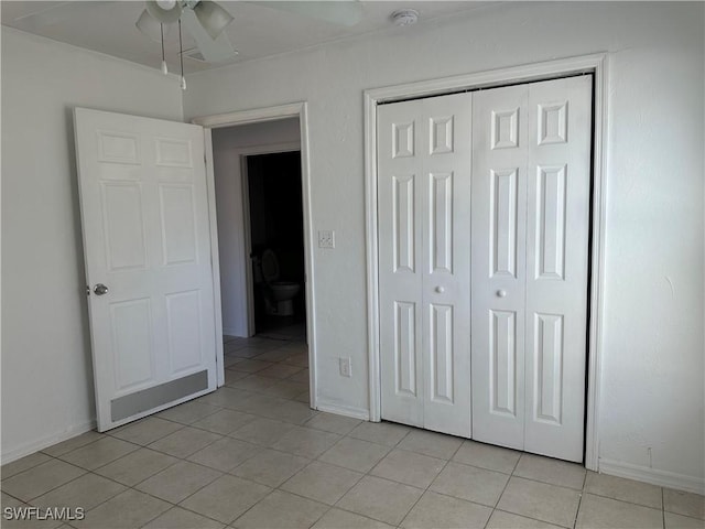 unfurnished bedroom featuring light tile patterned floors and a closet