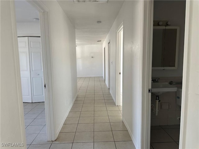 hall featuring light tile patterned floors