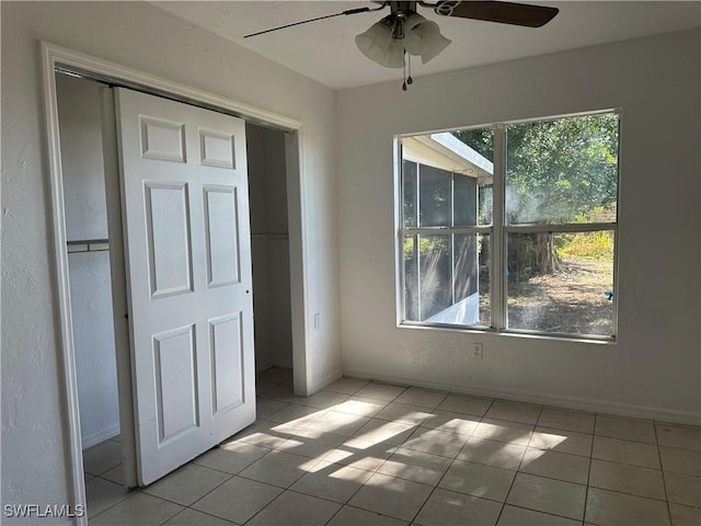 unfurnished bedroom featuring ceiling fan and light tile patterned floors