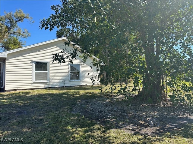 view of side of home featuring a yard