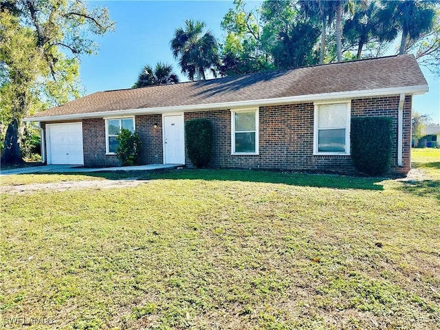 ranch-style house featuring a garage and a front yard