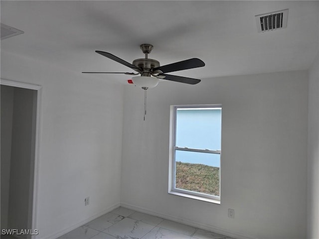 unfurnished room featuring a ceiling fan, baseboards, visible vents, and marble finish floor