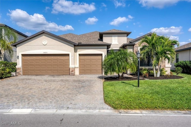 14693 Adina Ln, Fort Myers, FL 33905 - view of front of property with a garage and a front yard