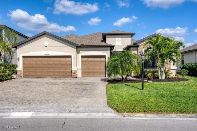 view of front of property with a garage and a front yard